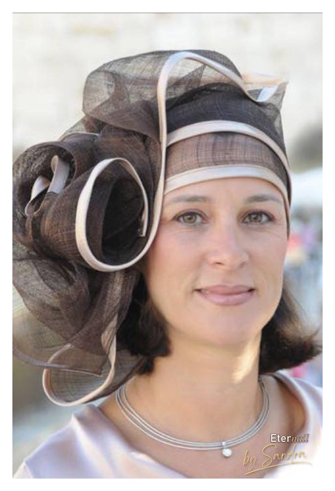 Elegant event makeup paired with a statement fascinator