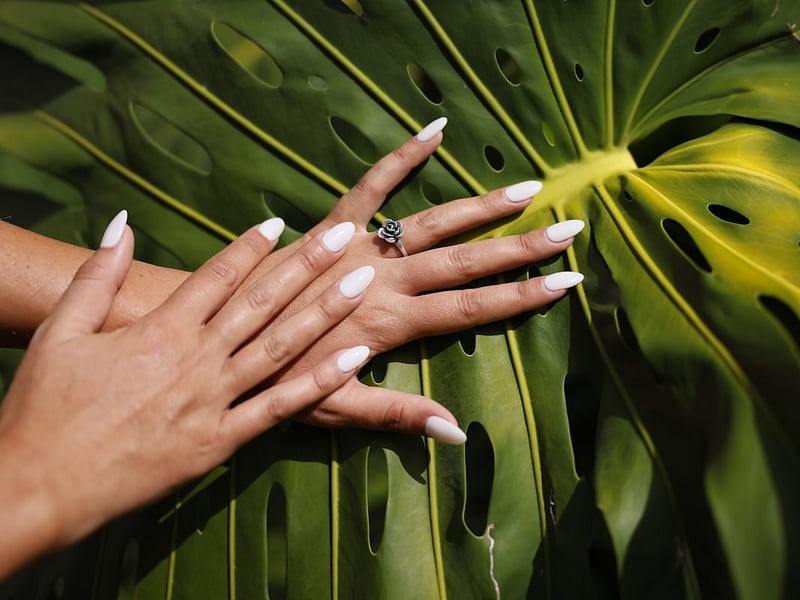 Placeholder — white almond-shaped manicure, close-up